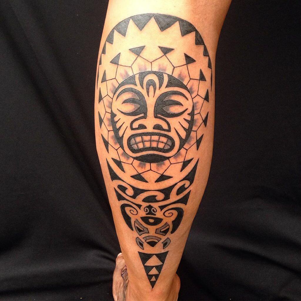 Tribal black sun tattoo on the right calf