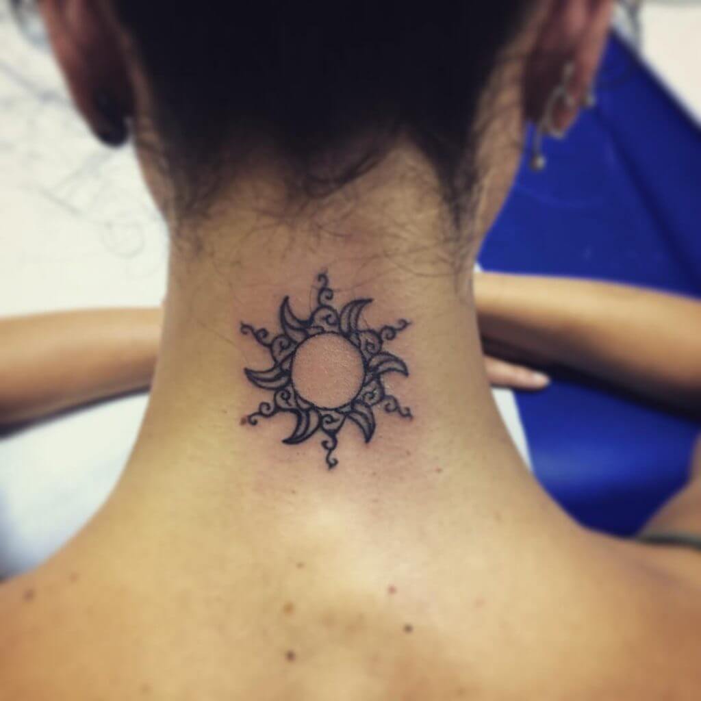 Tribal black sun tattoo on the neck