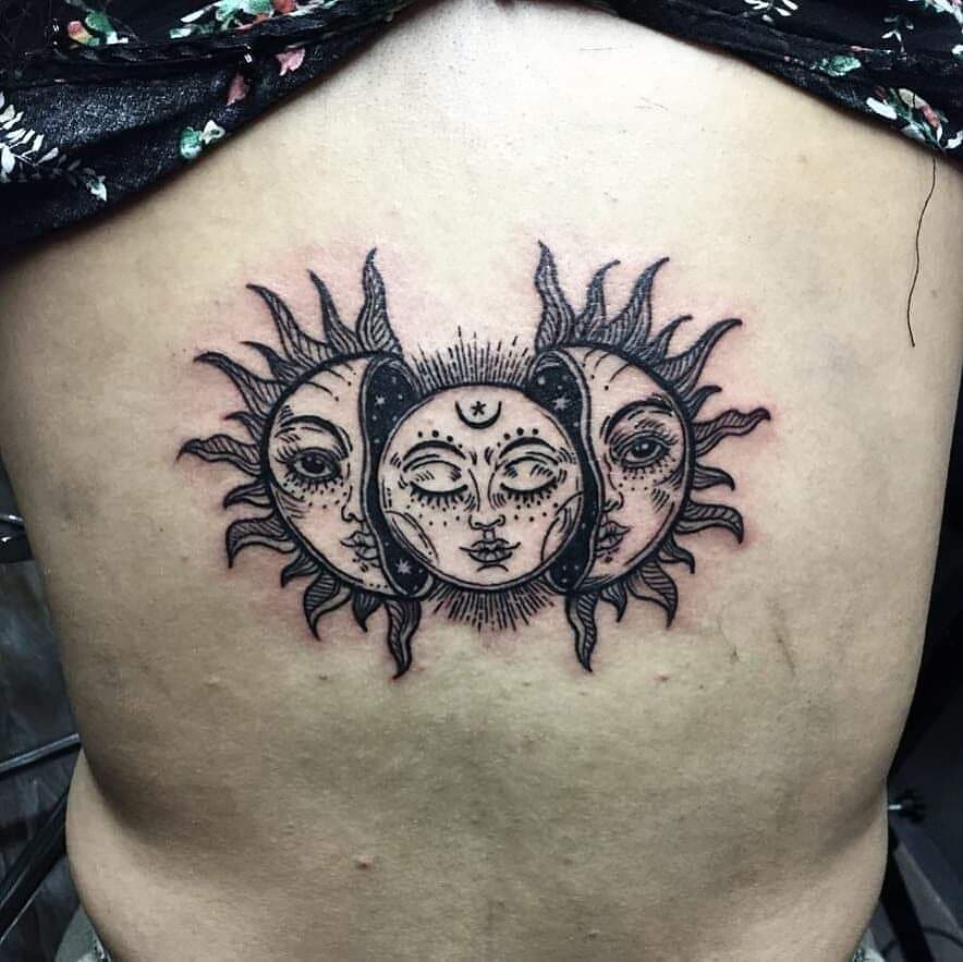 Black sun tattoo on the back
