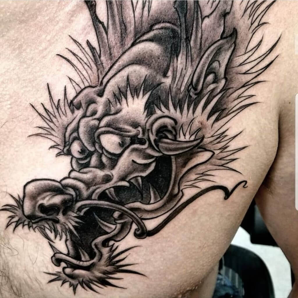 Black dragon tattoo for man on the left side of the chest
