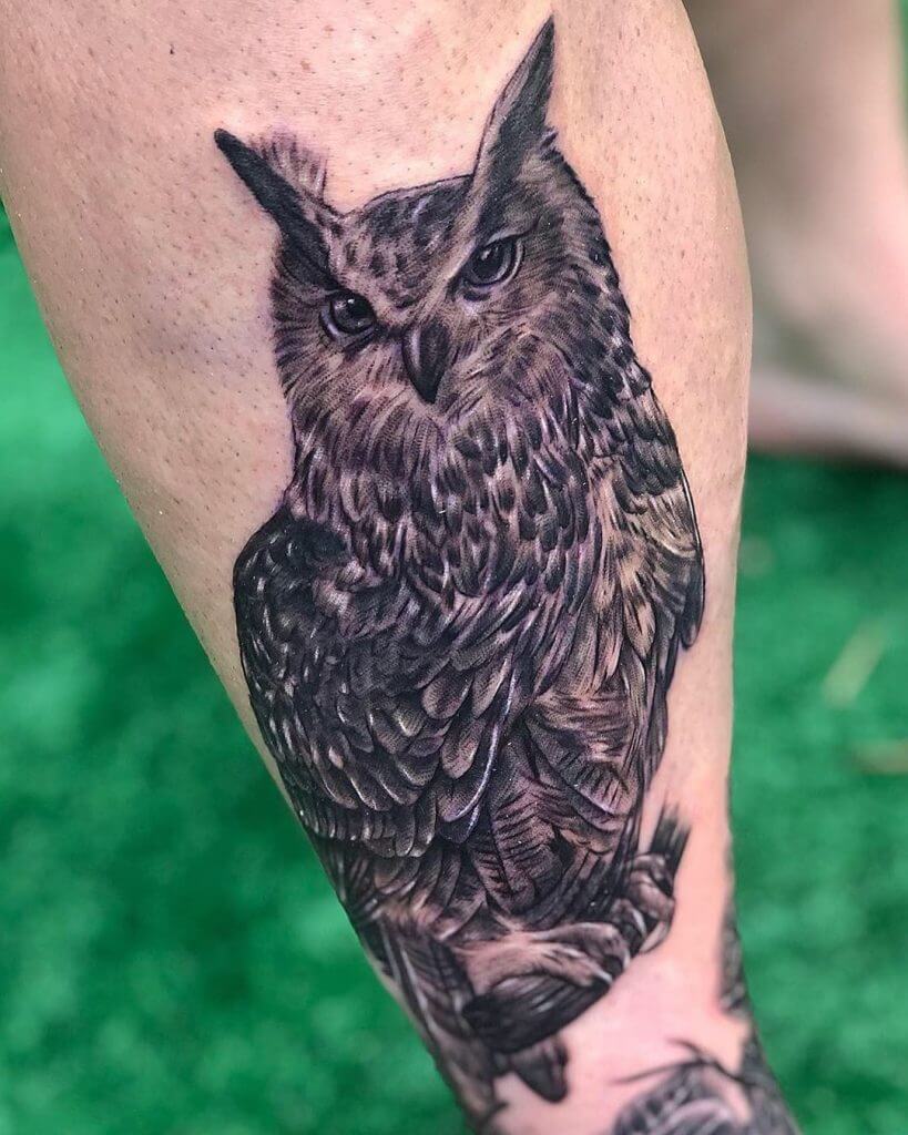 Black owl tattoo for men on the left calf