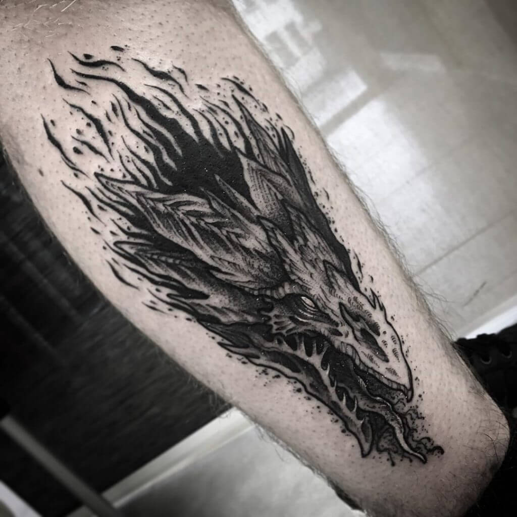 Black dragon tattoo for man on the right calf