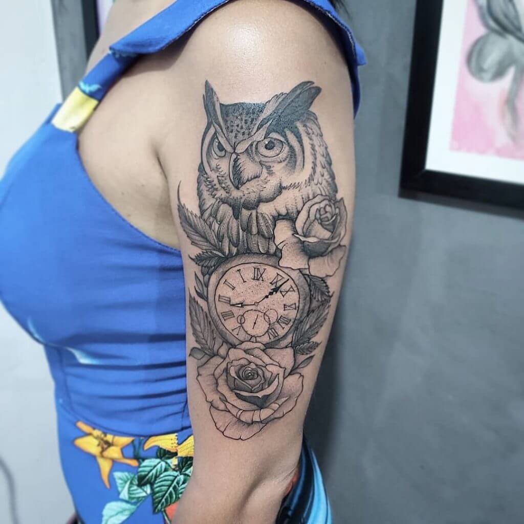 Black owl tattoo with a clock and a rose for women on the left arm