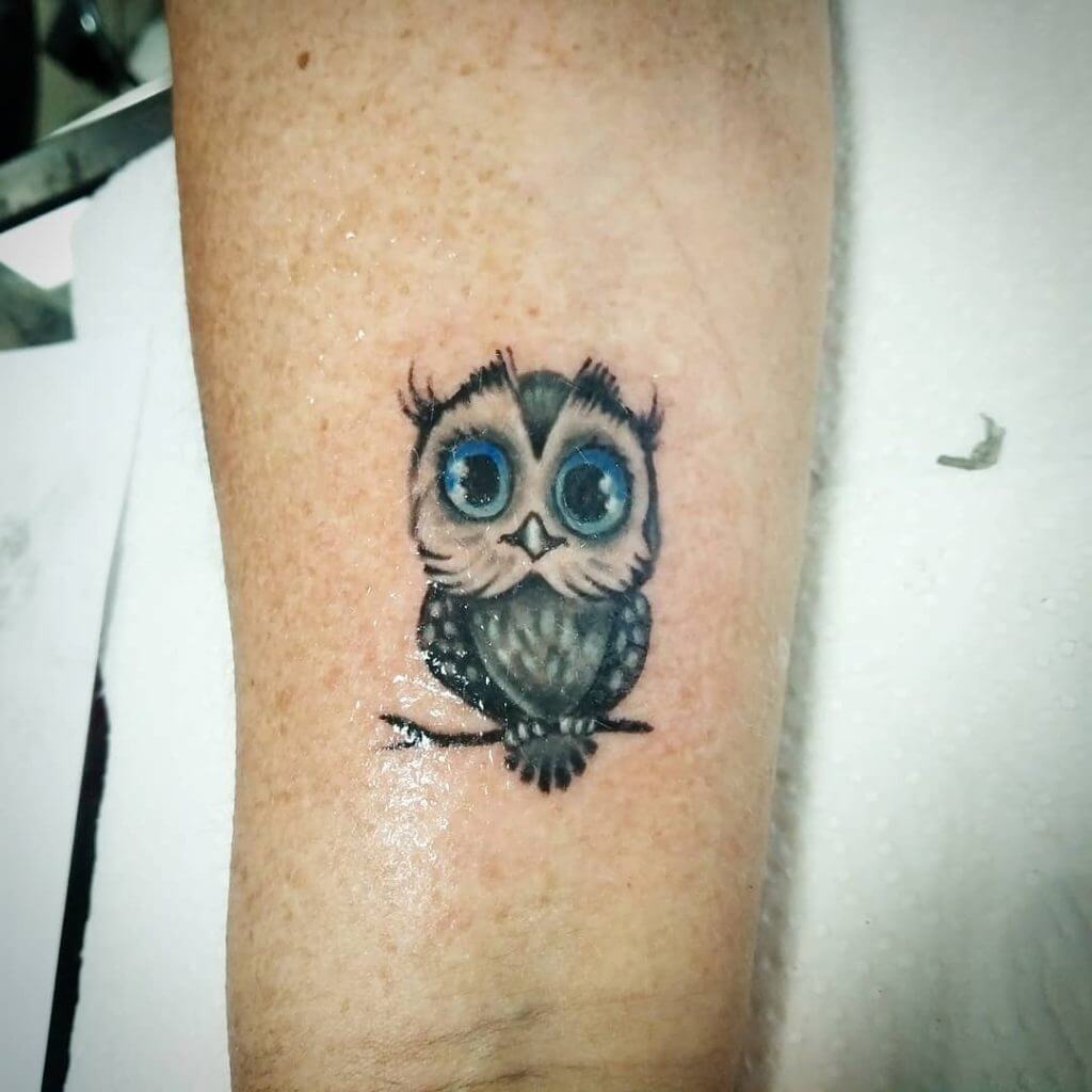 Black small owl tattoo with blue eyes for women