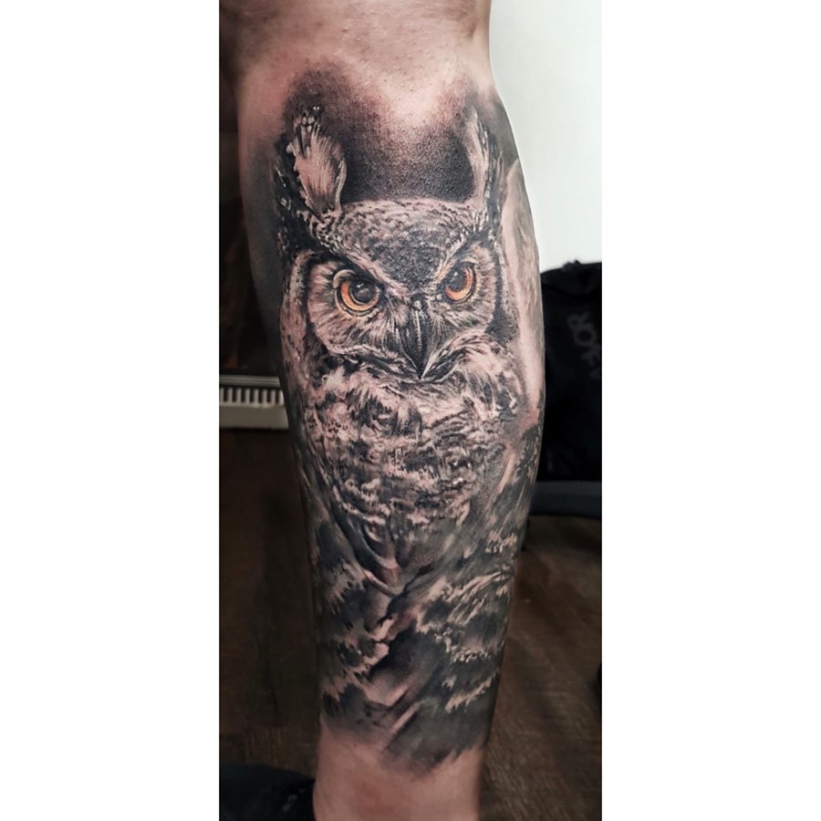 Black owl tattoo with lantern for men on the right calf