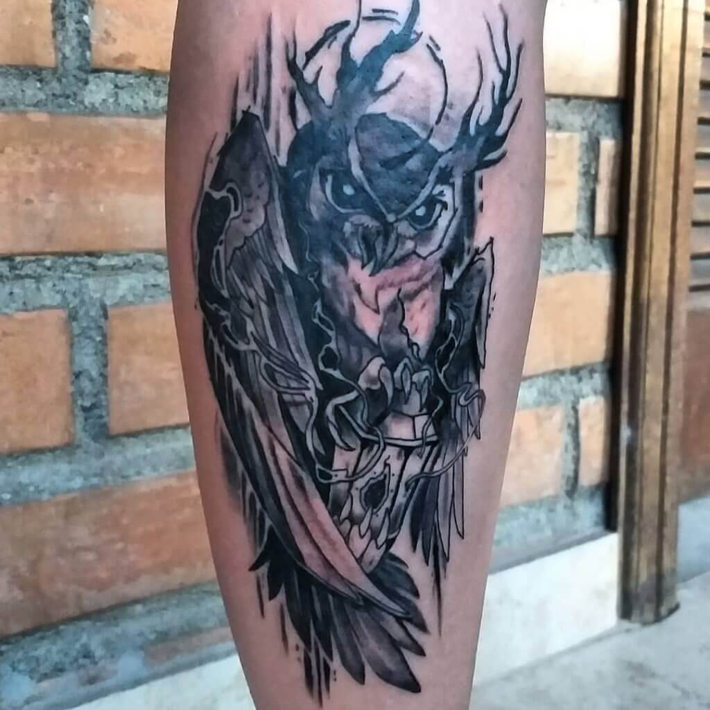 Black owl tattoo with lantern for men on the left calf