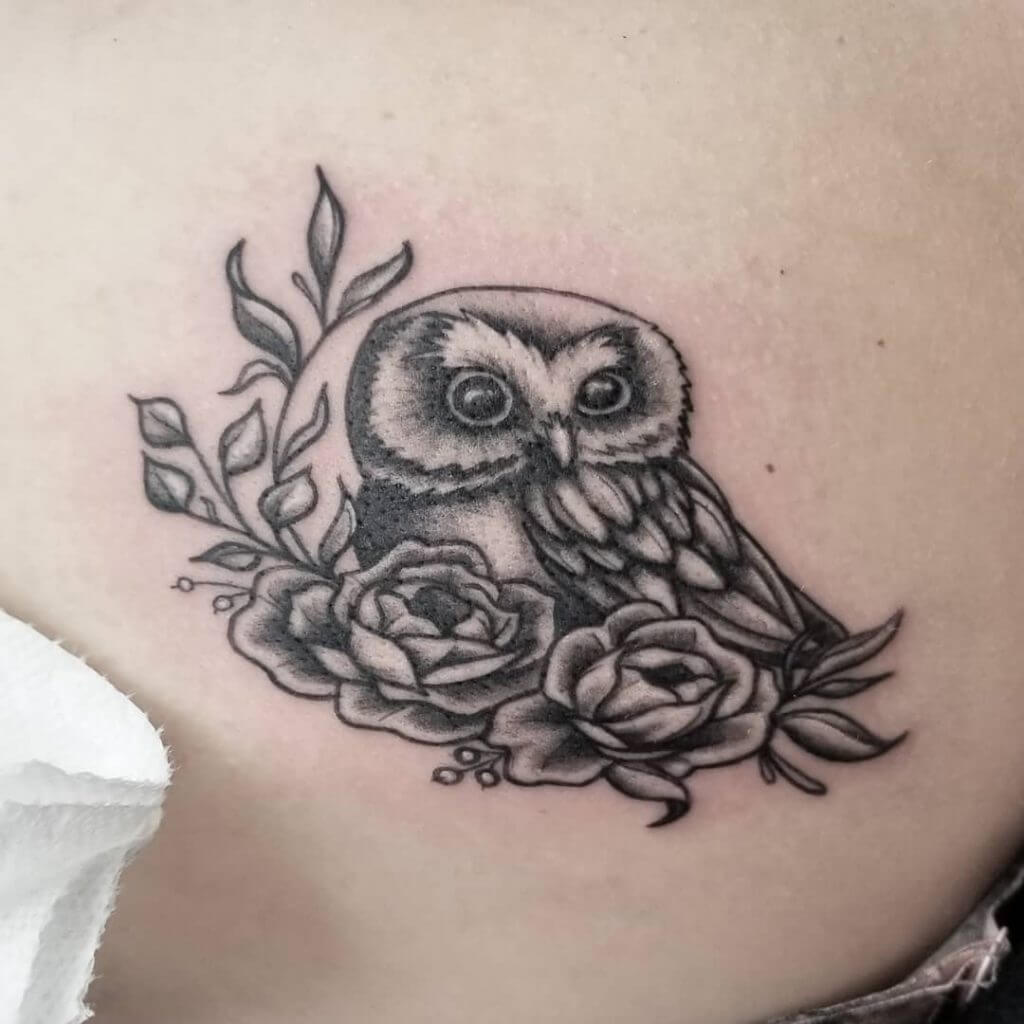 Black owl tattoo with roses for women