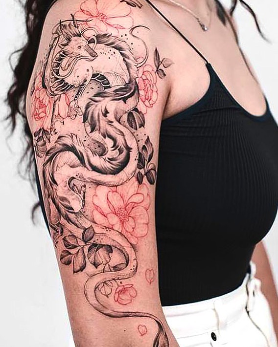 Black dragon tattoo with a red rouses for woman on the right arm