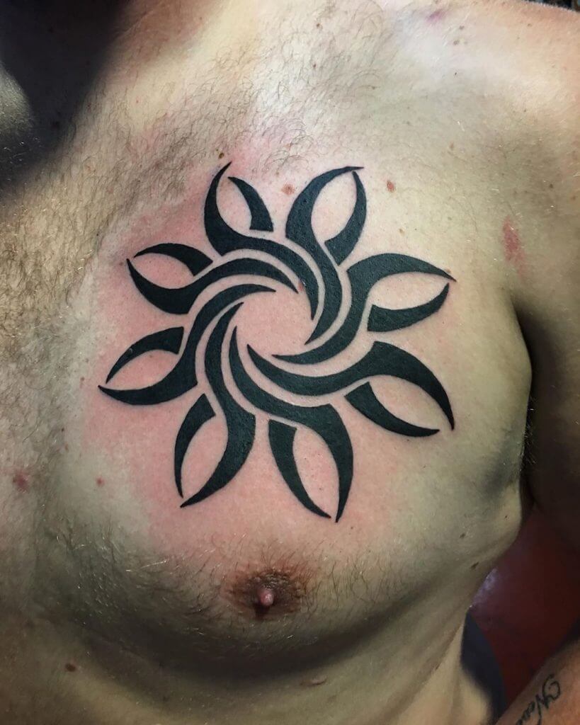 Tribal black sun tattoo on the chest