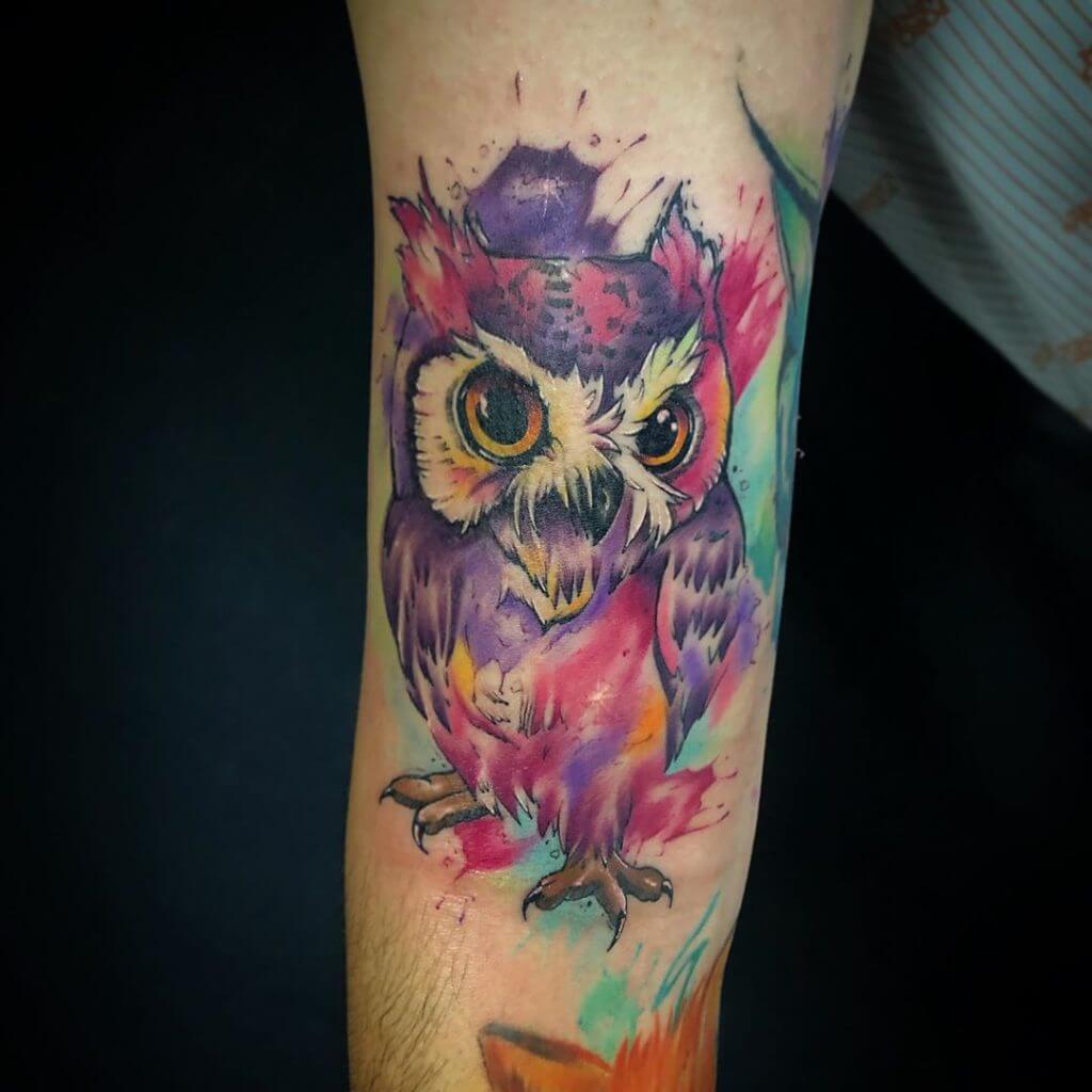 Watercolor owl tattoo for men on the right forearm