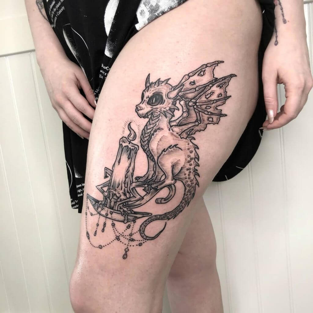 Black dragon tattoo with a candle, for woman on the left thigh