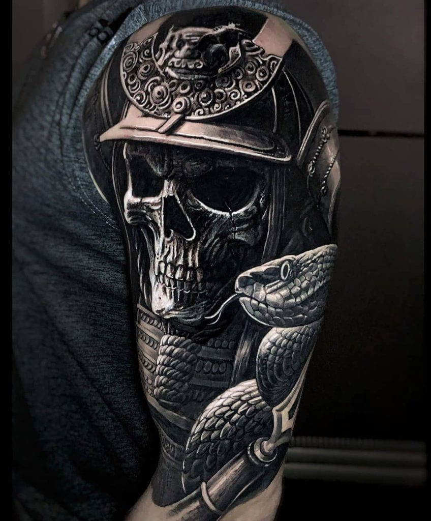 Black and gray samurai mask tattoo on the arm