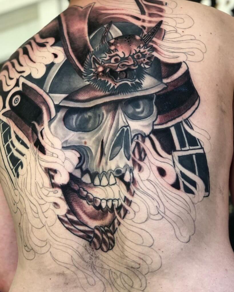 Black and gray samurai mask tattoo on the back