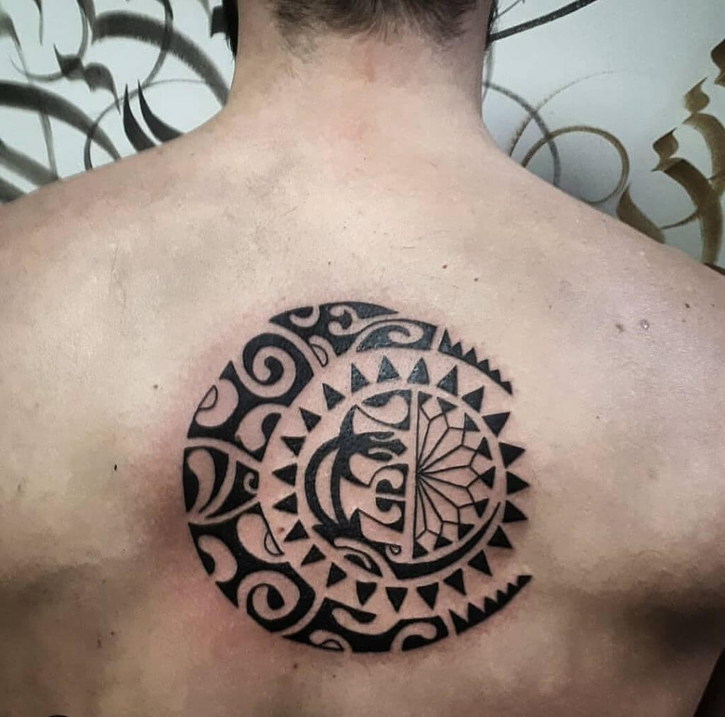 Tribal black sun tattoo on the back