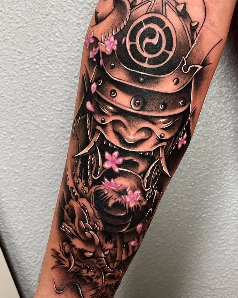 Black and gray samurai mask tattoo on the forearm