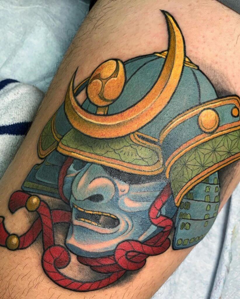 Color samurai mask tattoo on the thigh