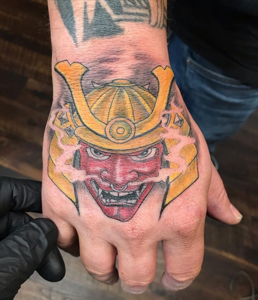 Color samurai mask tattoo on the hand