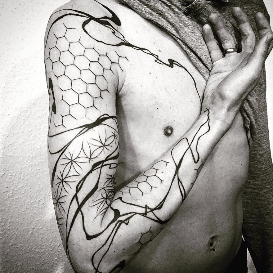 Abstract geometric tattoo on the right arm