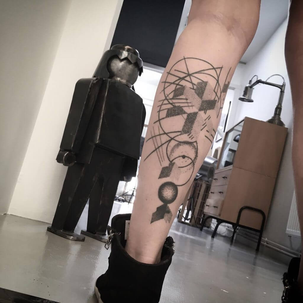 Abstract geometric tattoo on the left calf
