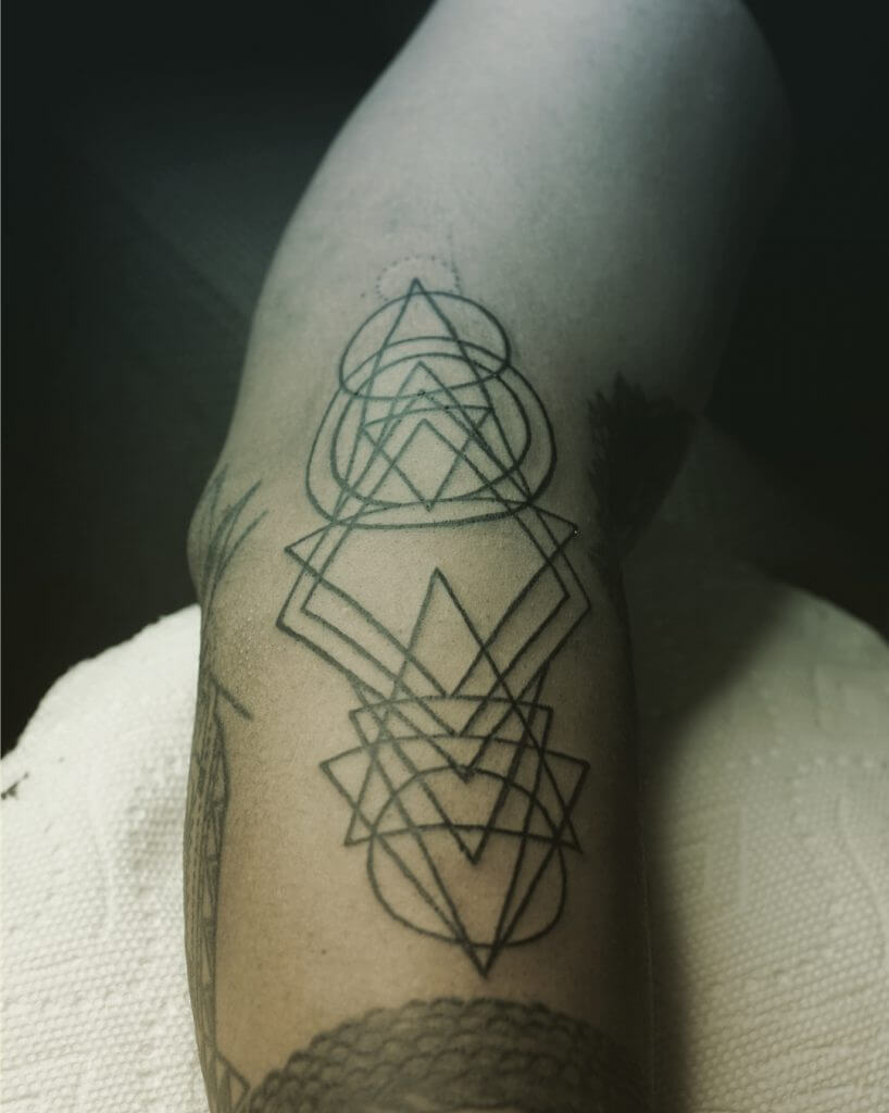 Abstract geometric tattoo on the right forearm