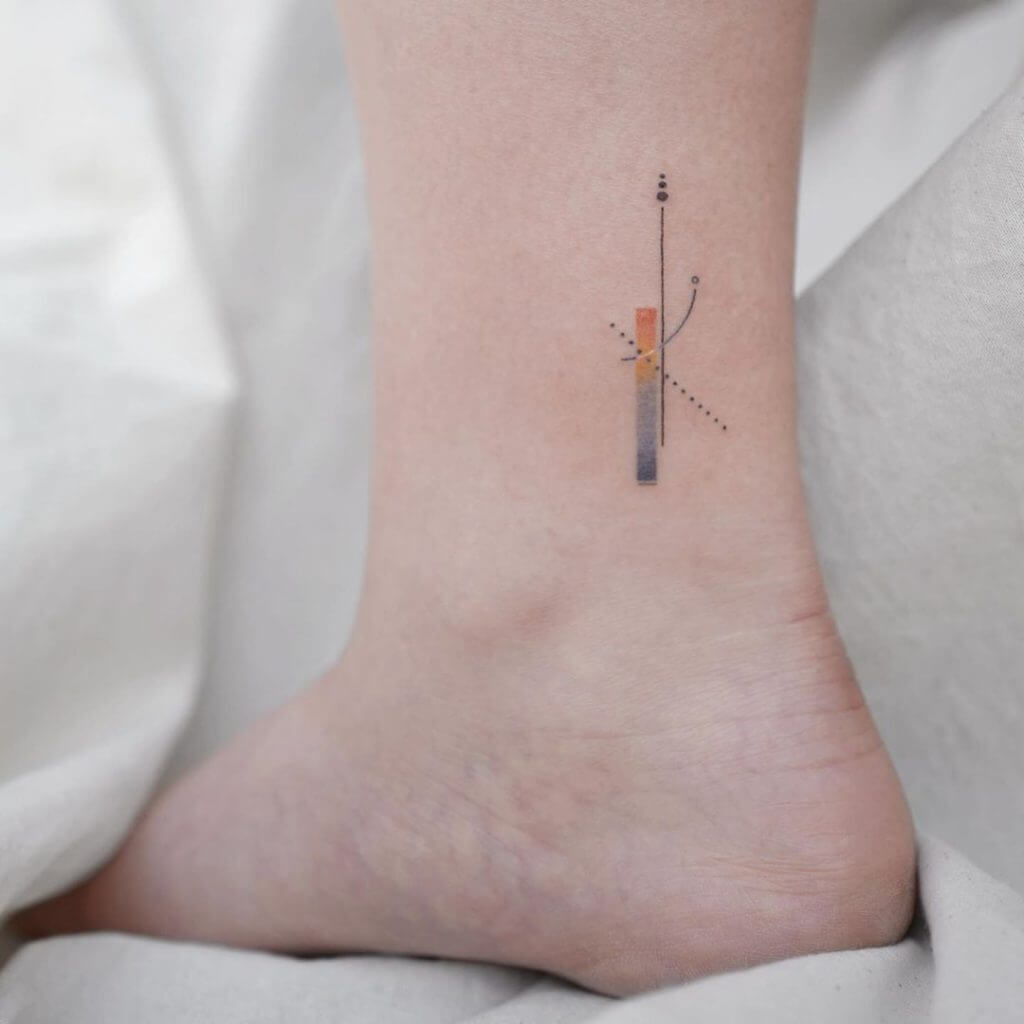 Small color abstract tattoo above the right ankle