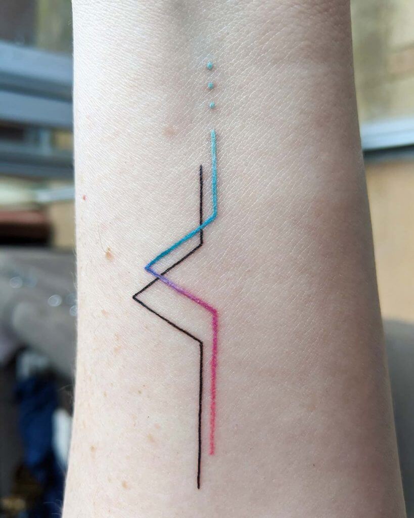 Small color abstract tattoo on the left forearm