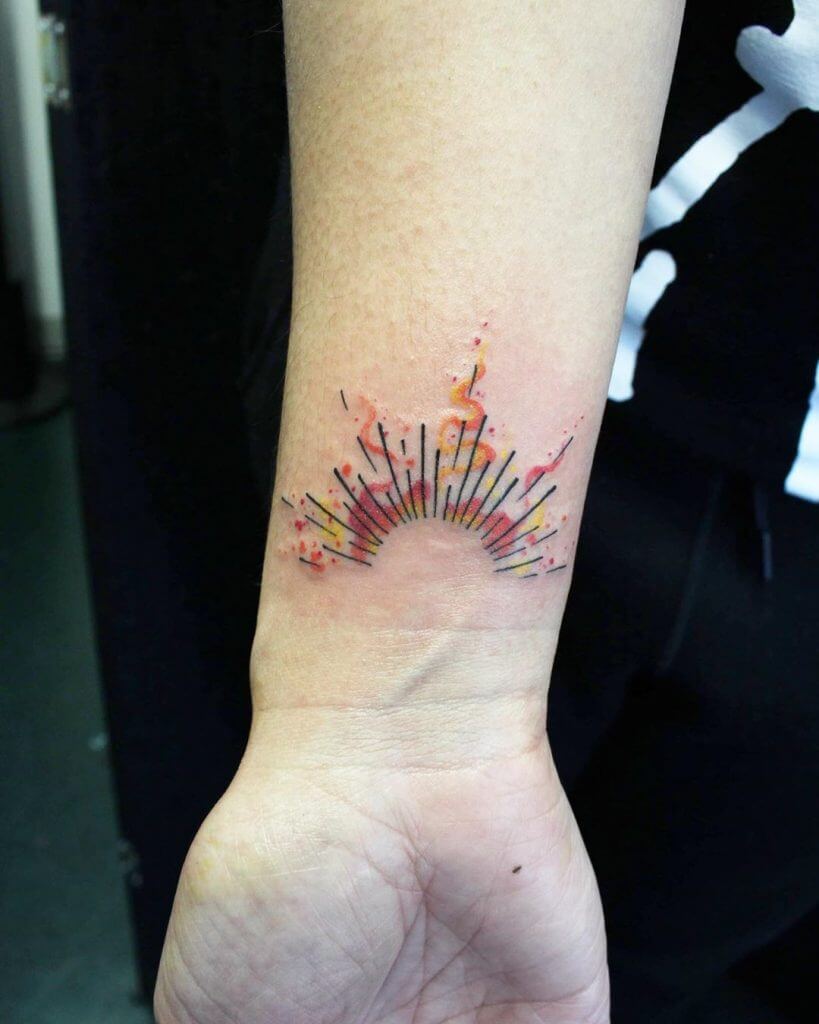 Small color abstract tattoo on the right forearm