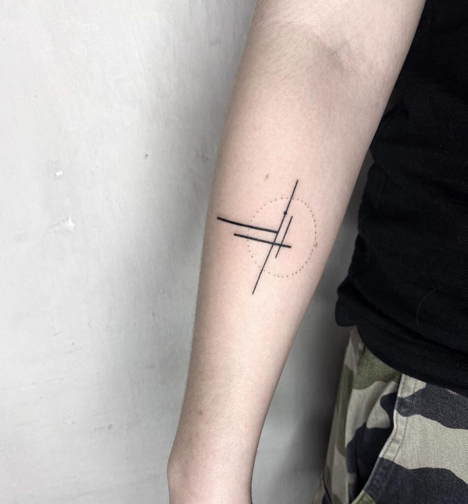 Small black abstract tattoo on the right forearm