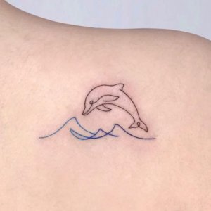 If you like simplicity here are 10 examples of simple dolphin tattoo 4