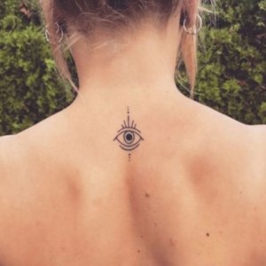 Authentic female evil eye tattoos on back 4