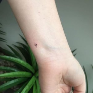 small lightning tattoo on hand