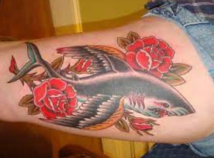 Traditional shark tattoo with an open mouth and wings