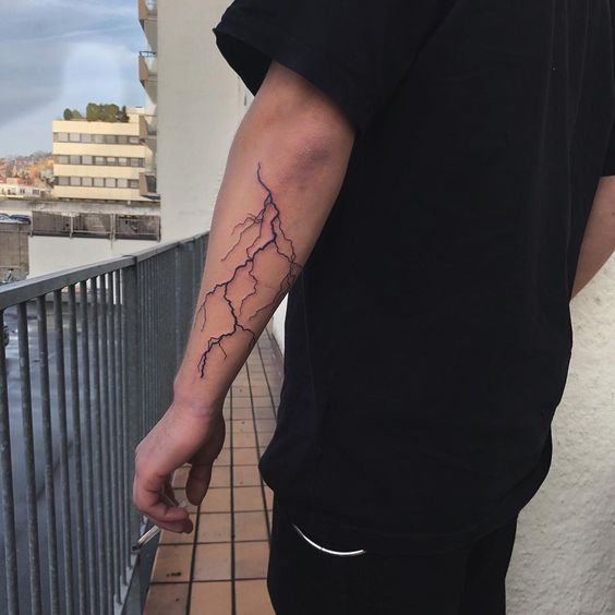 Bold forearm lightning tattoo design capturing the essence of speed, agility, and sudden change.