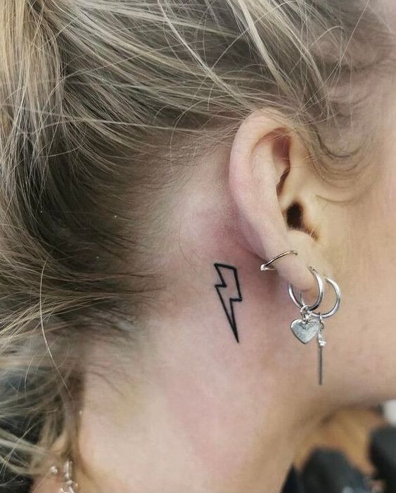Minimalistic ear lightning tattoo design, symbolizing the simplicity and directness of nature's power.