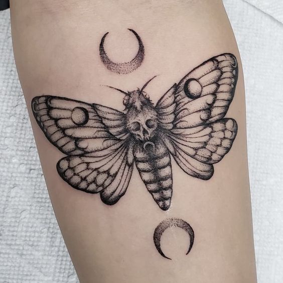 Forearm moth tattoo