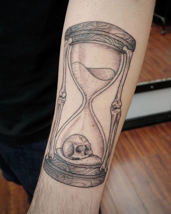 Forearm hourglass tattoo with skull