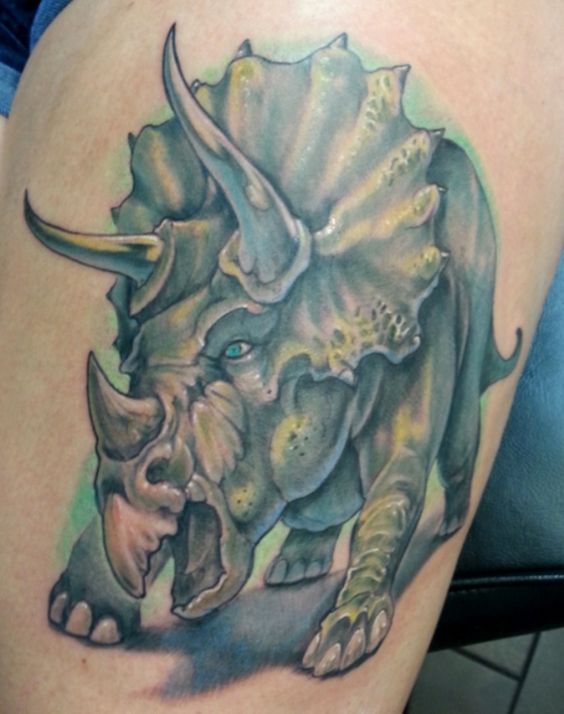 Thigh dinosaur tattoo