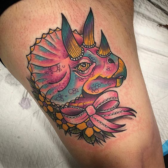 Thigh dinosaur tattoo