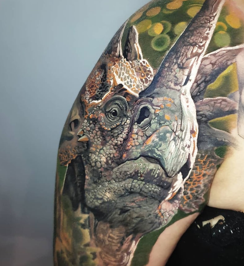 Shoulder dinosaur tattoo
