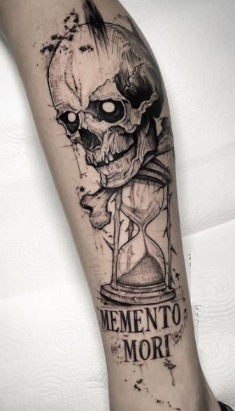 Calf memento mori tattoo with a skull and hourglass
