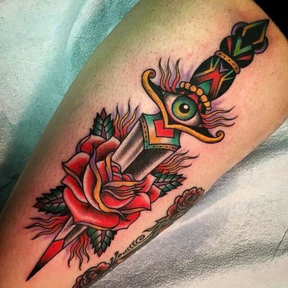 Calf rose dagger tattoo