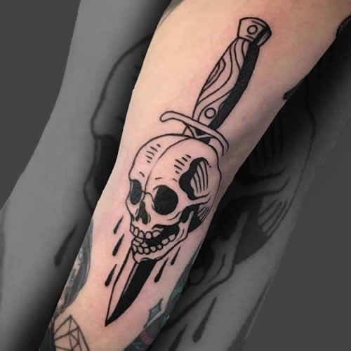 Arm skull dagger tattoo