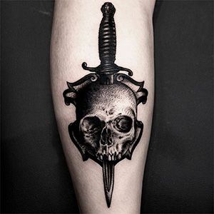 Calf skull dagger tattoo