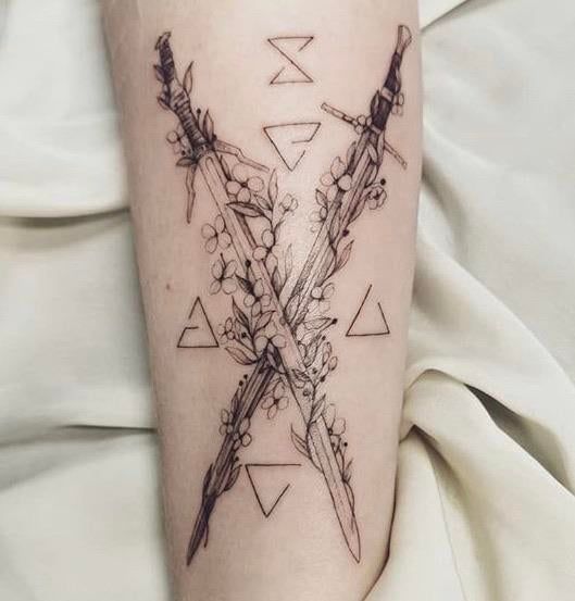 Forearm two swords tattoo