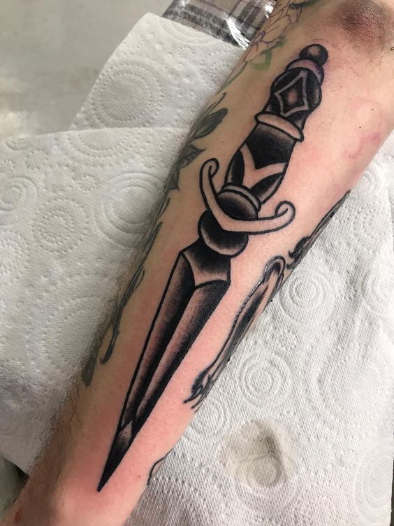 Forearm dagger tattoo