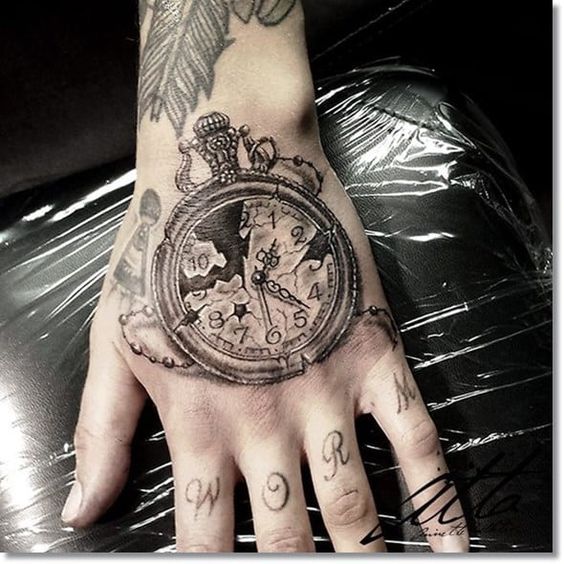Old and broken clock tattoo on the top of the hand