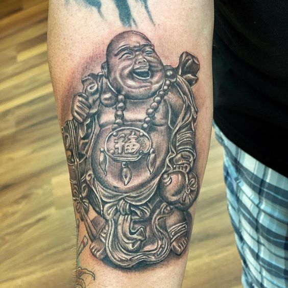 The Laughing Buddha forearm tattoo