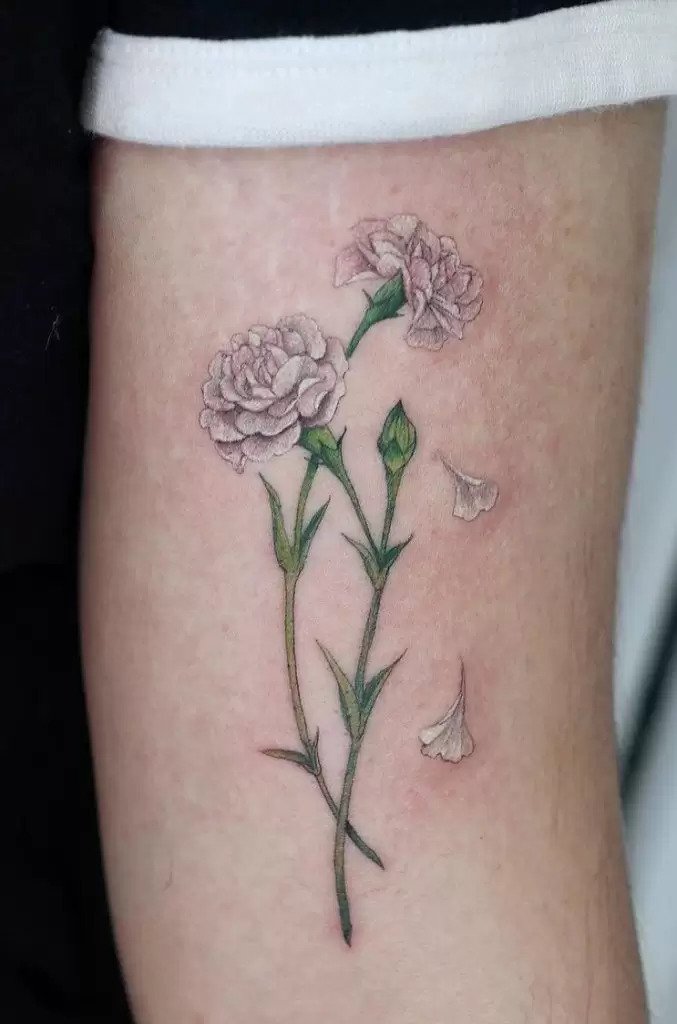 White carnation tattoo on the arm
