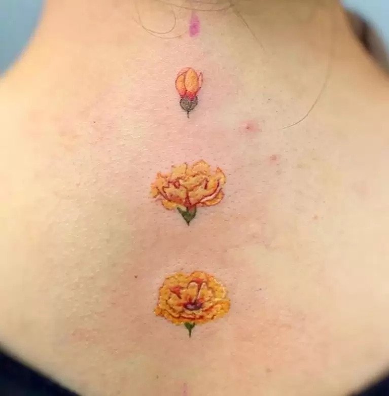 Yellow back Carnation tattoo