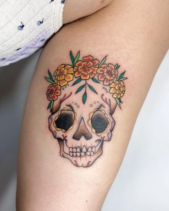 Calf Marigold tattoo with skull